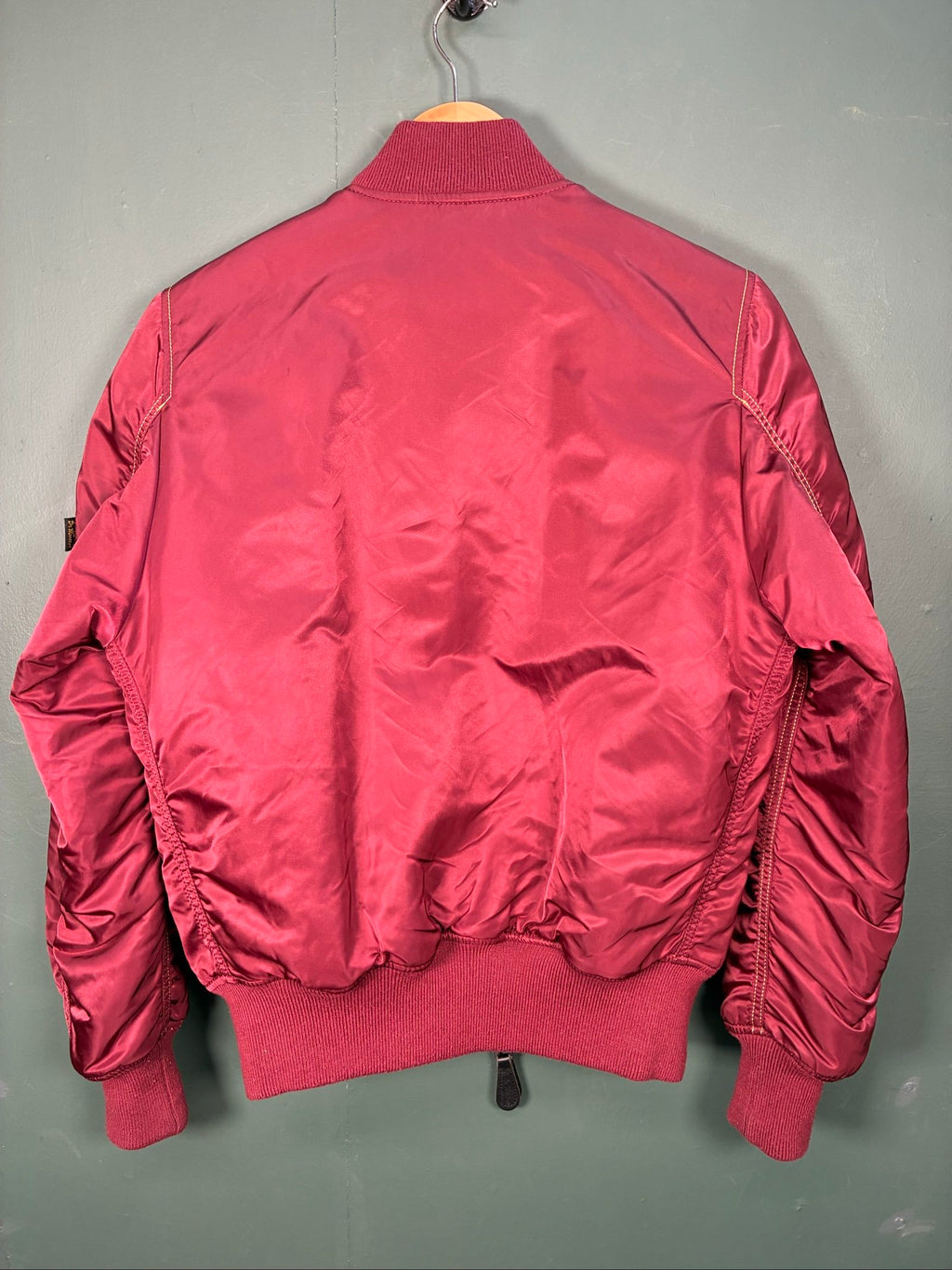 Alpha Industries burgundy bomber jacket reversible with yellow and red accents, excellent condition.