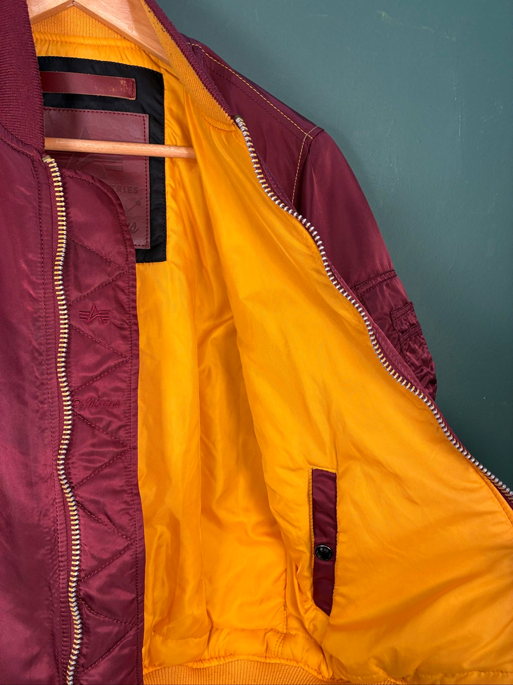 Alpha Industries burgundy bomber jacket reversible with yellow and red accents, excellent condition.