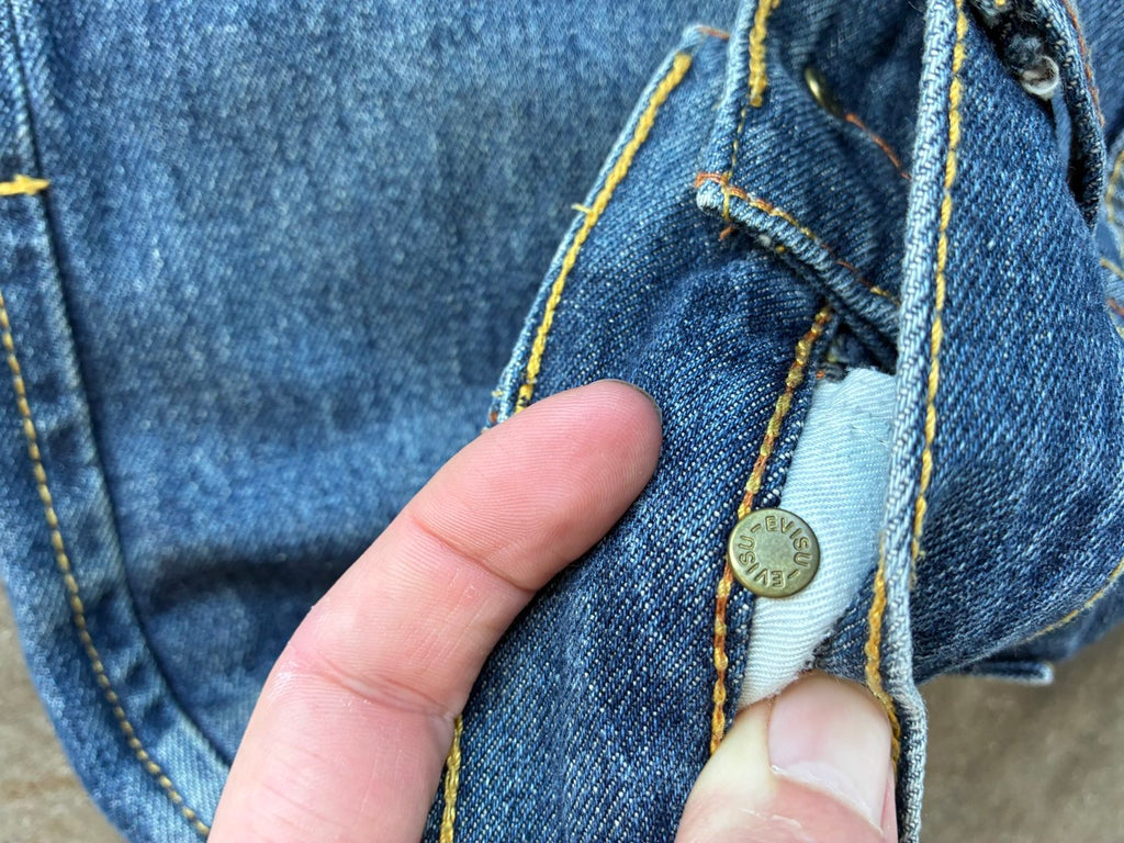 Evisu blue denim jeans with koi fish embroidery and logo, vintage Japanese style.