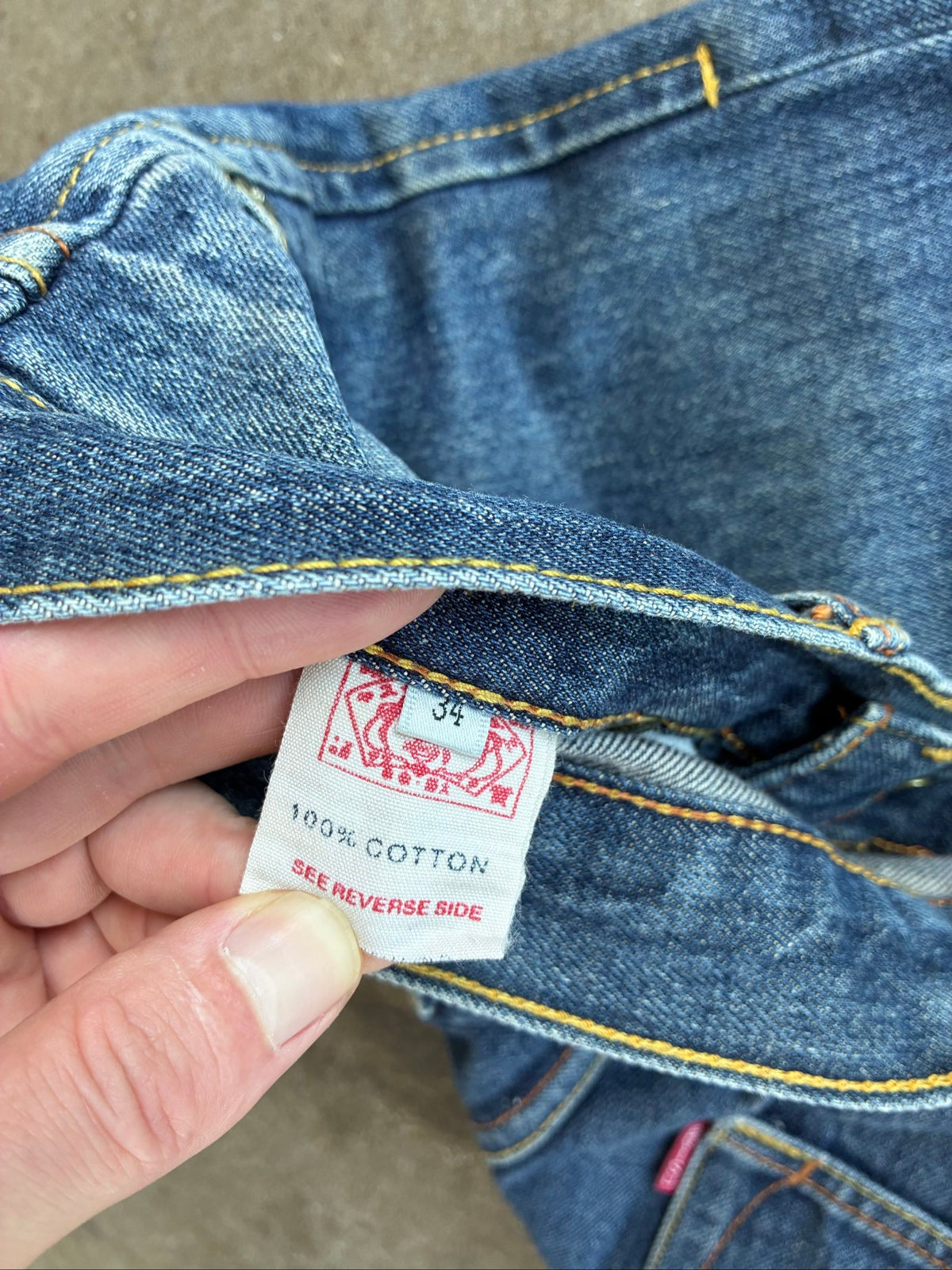 Evisu blue denim jeans with koi fish embroidery and logo, vintage Japanese style.