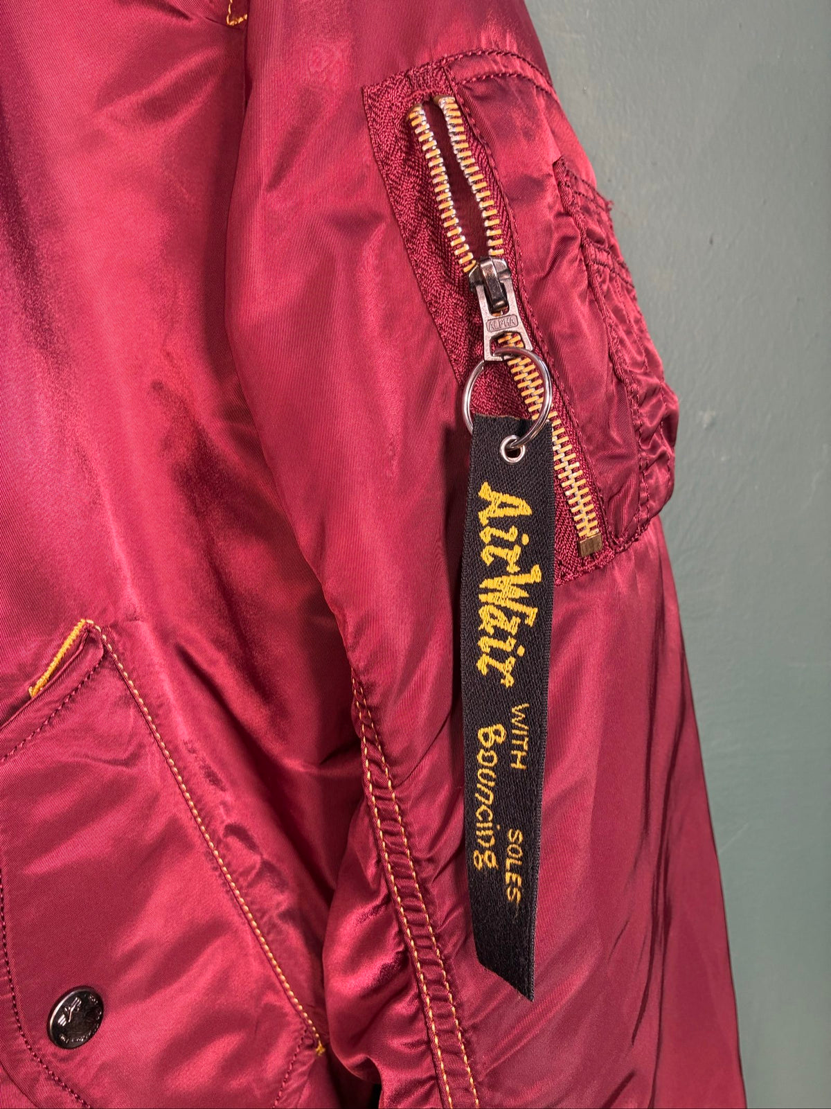 Alpha Industries burgundy bomber jacket reversible with yellow and red accents, excellent condition.