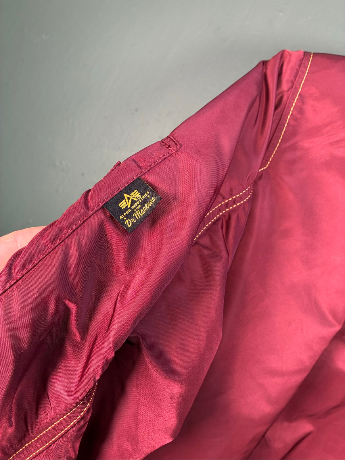 Alpha Industries burgundy bomber jacket reversible with yellow and red accents, excellent condition.