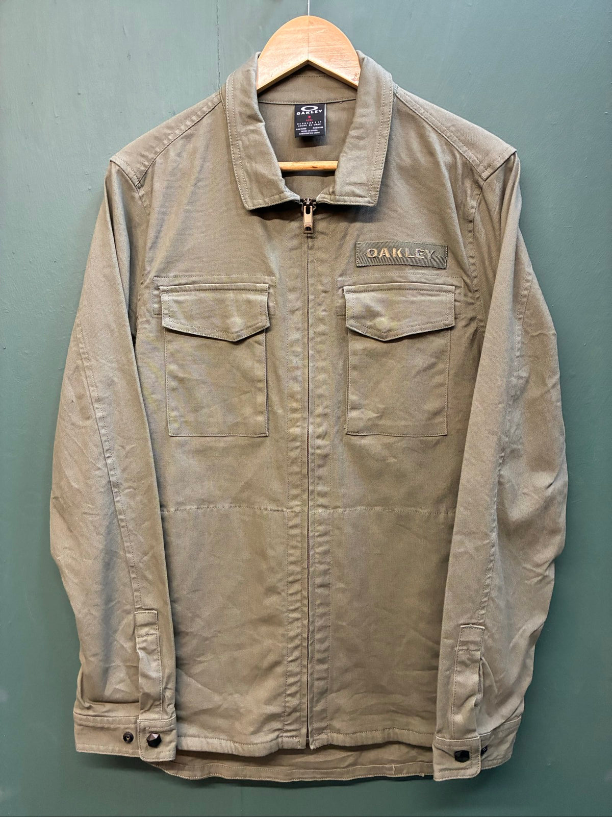 Oakley khaki military field jacket with breast and side pockets, regular fit.