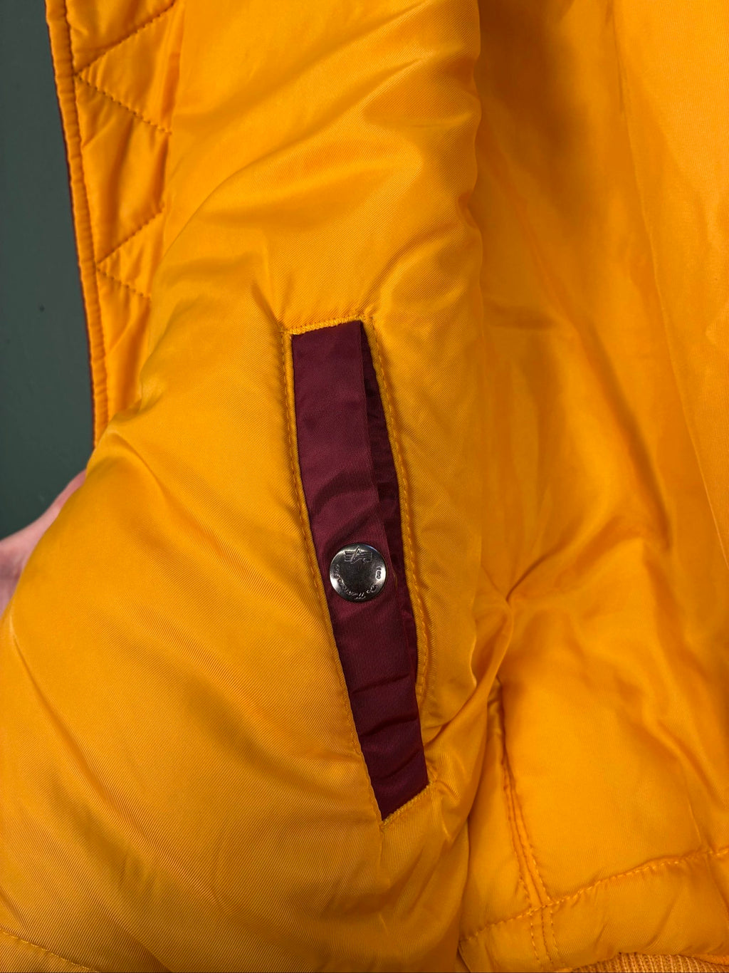 Alpha Industries burgundy bomber jacket reversible with yellow and red accents, excellent condition.