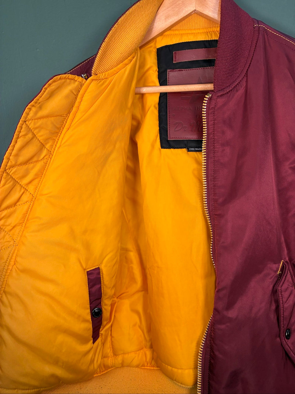 Alpha Industries burgundy bomber jacket reversible with yellow and red accents, excellent condition.