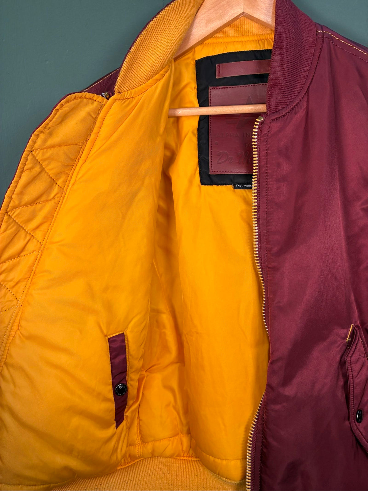 Alpha Industries burgundy bomber jacket reversible with yellow and red accents, excellent condition.