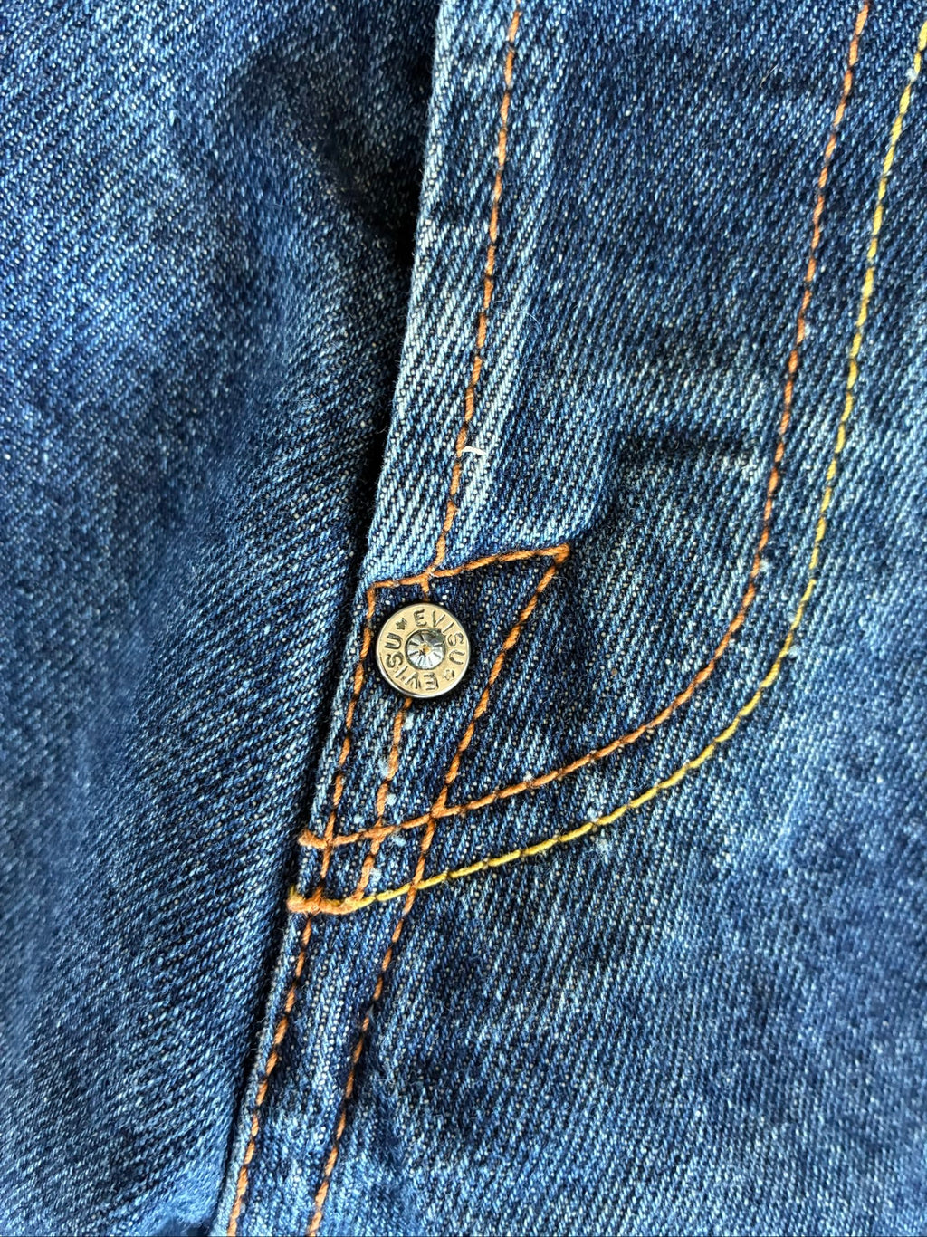 Evisu blue denim jeans with koi fish embroidery and logo, vintage Japanese style.