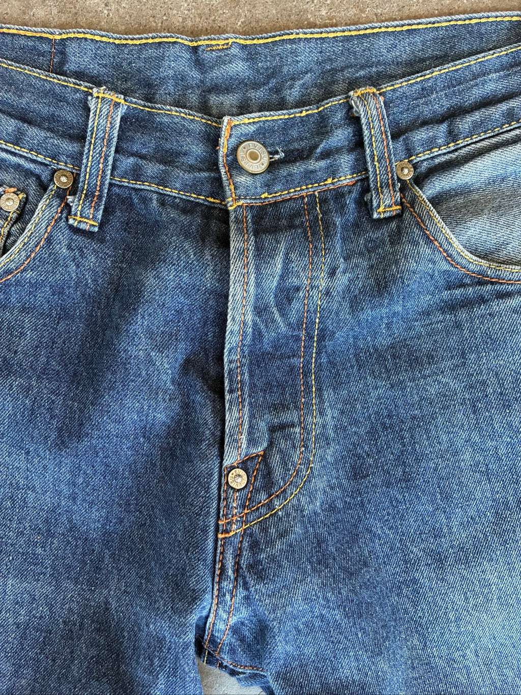 Evisu blue denim jeans with koi fish embroidery and logo, vintage Japanese style.