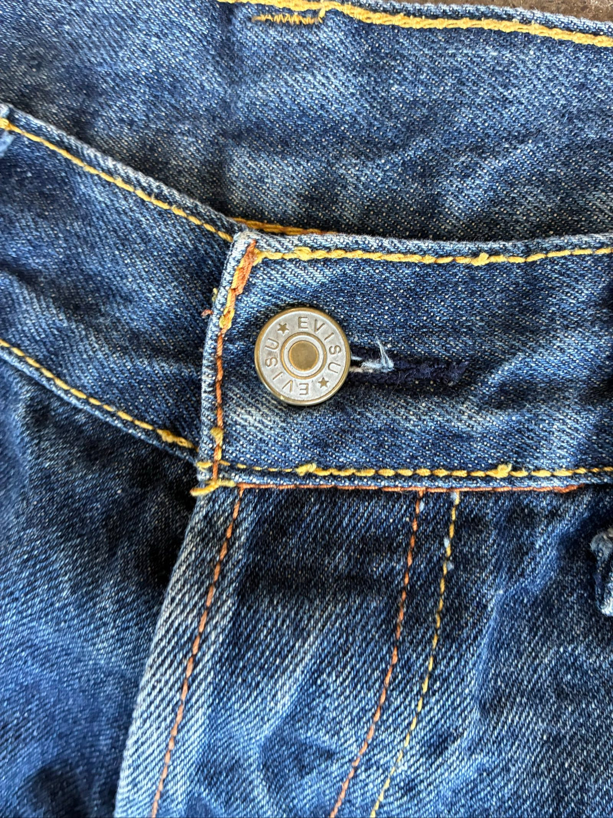 Evisu blue denim jeans with koi fish embroidery and logo, vintage Japanese style.