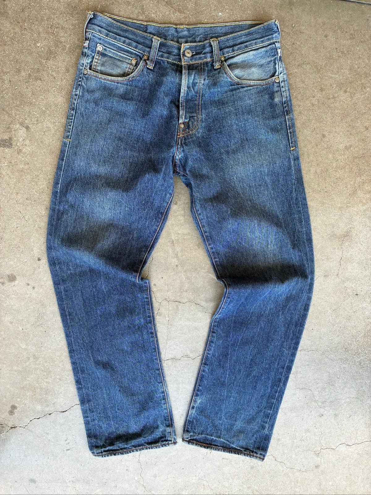 Evisu blue denim jeans with koi fish embroidery and logo, vintage Japanese style.