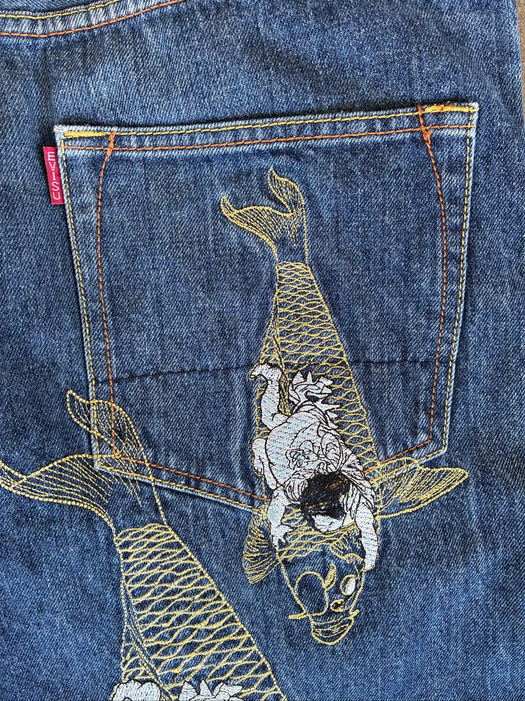 Evisu blue denim jeans with koi fish embroidery and logo, vintage Japanese style.