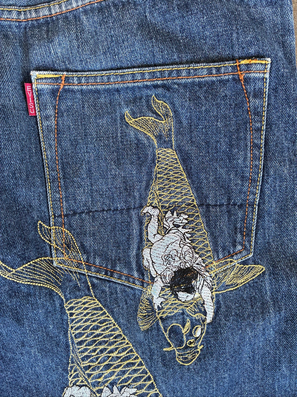 Evisu blue denim jeans with koi fish embroidery and logo, vintage Japanese style.