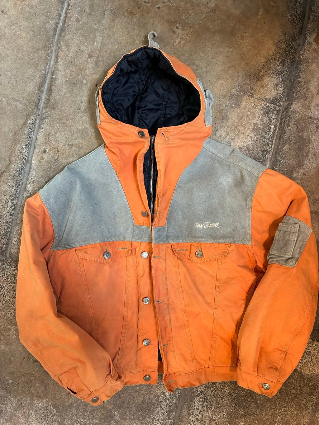 Diesel orange and grey hooded jacket with insulated design and vintage 90s style.