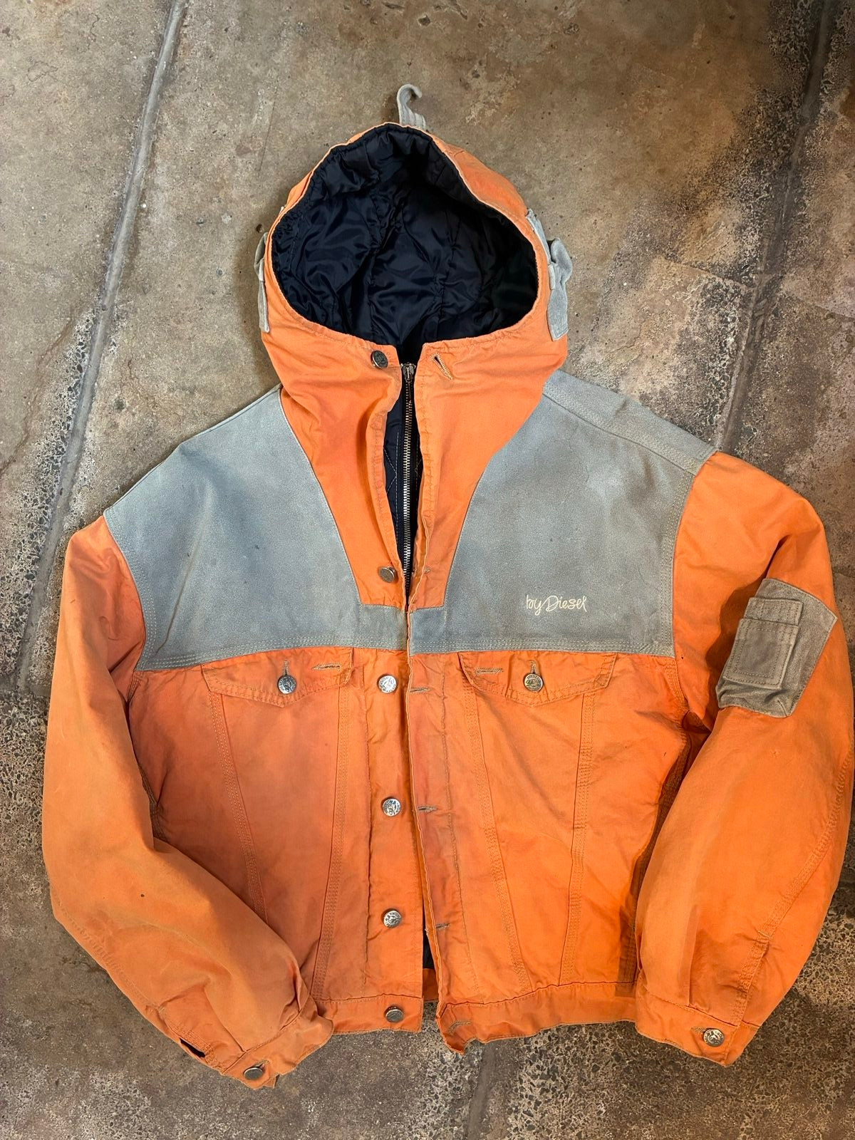 Diesel orange and grey hooded jacket with insulated design and vintage 90s style.