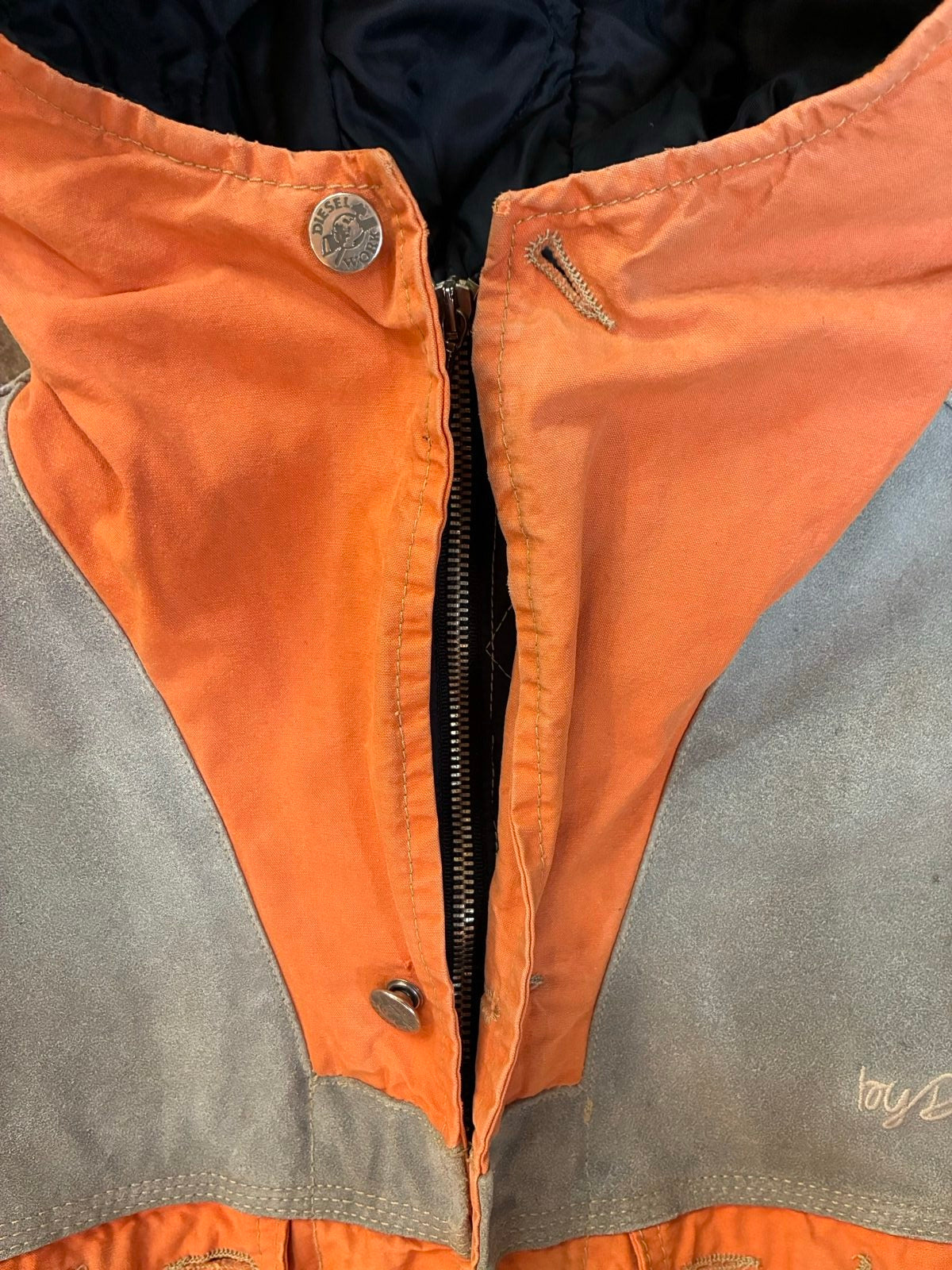 Diesel orange and grey hooded jacket with insulated design and vintage 90s style.