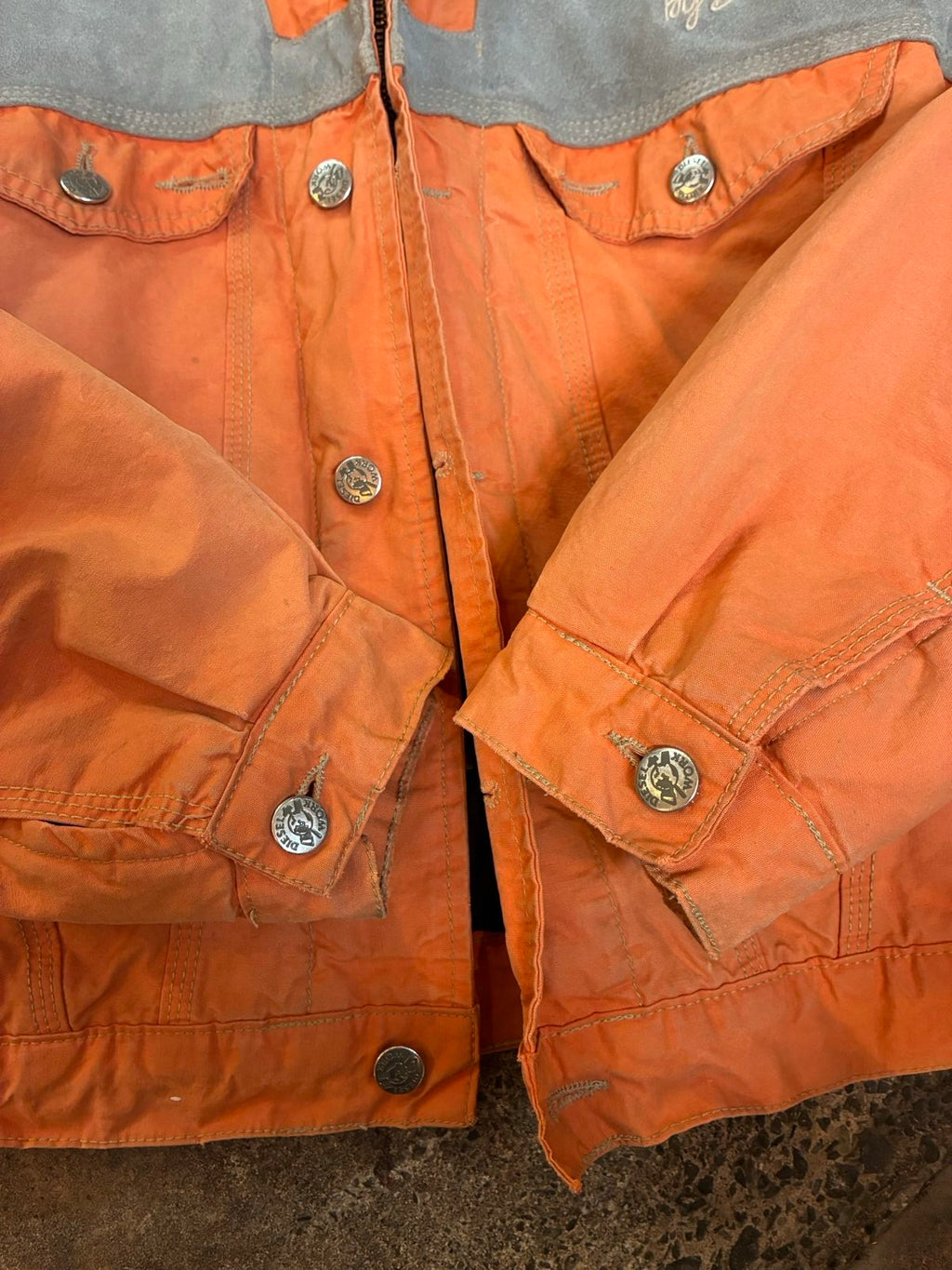 Diesel orange and grey hooded jacket with insulated design and vintage 90s style.