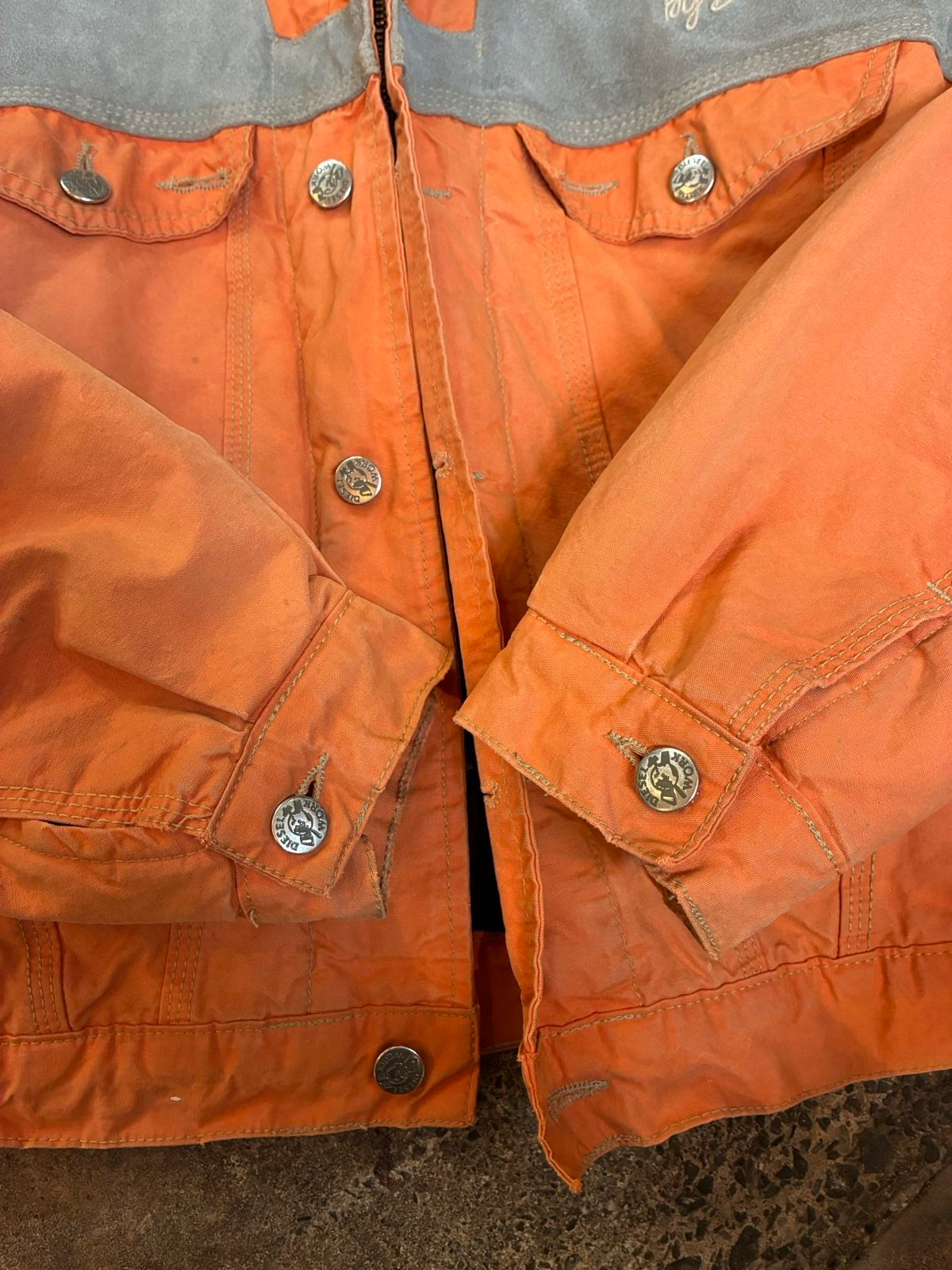 Diesel orange and grey hooded jacket with insulated design and vintage 90s style.