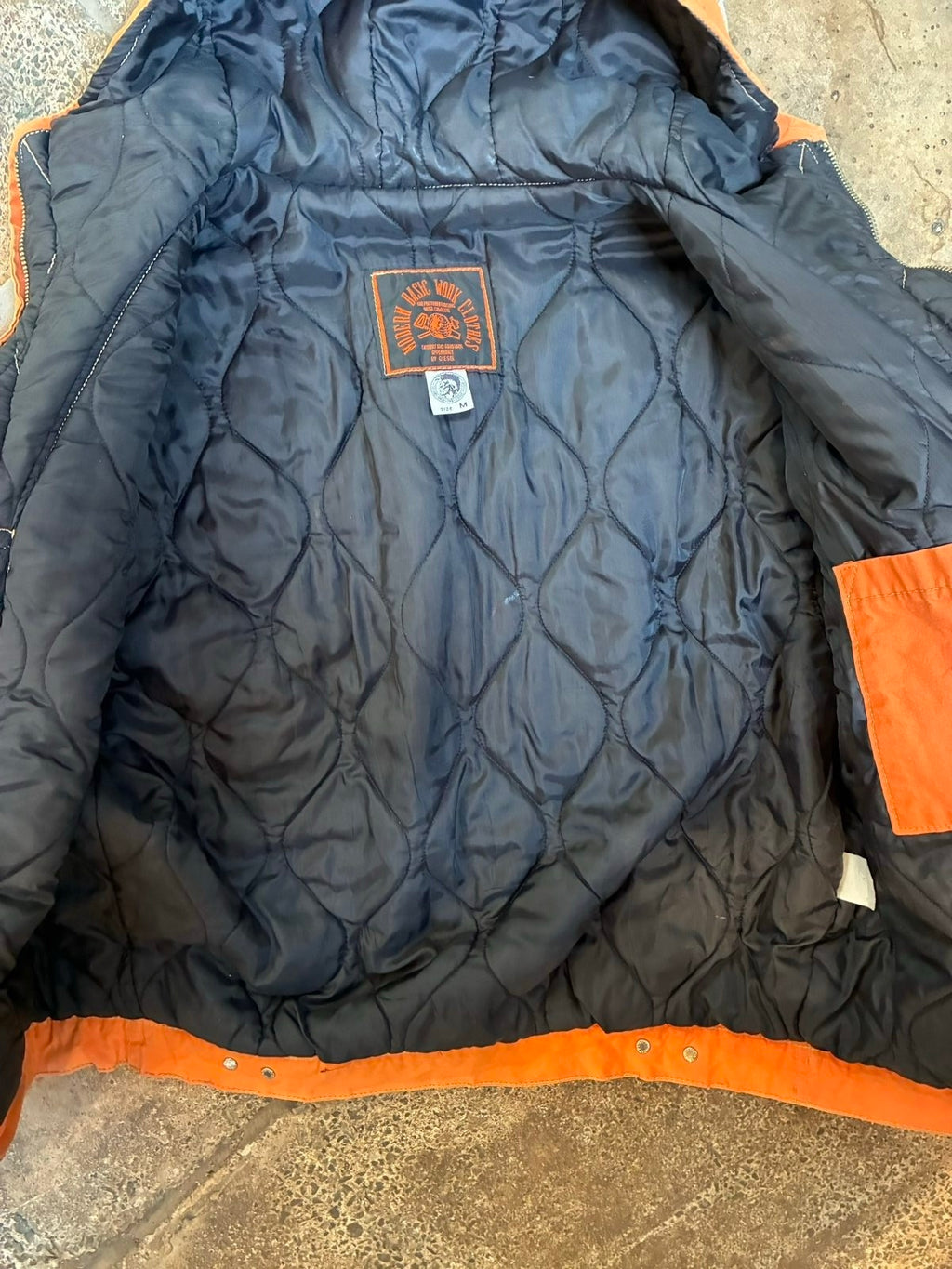 Diesel orange and grey hooded jacket with insulated design and vintage 90s style.