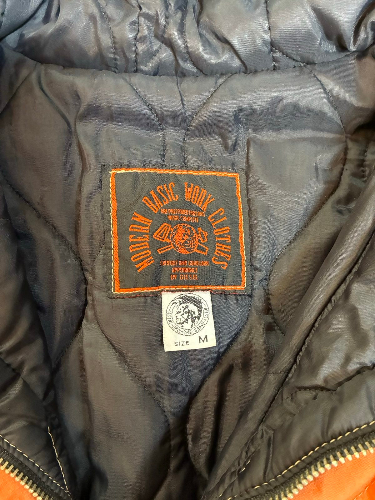 Diesel orange and grey hooded jacket with insulated design and vintage 90s style.
