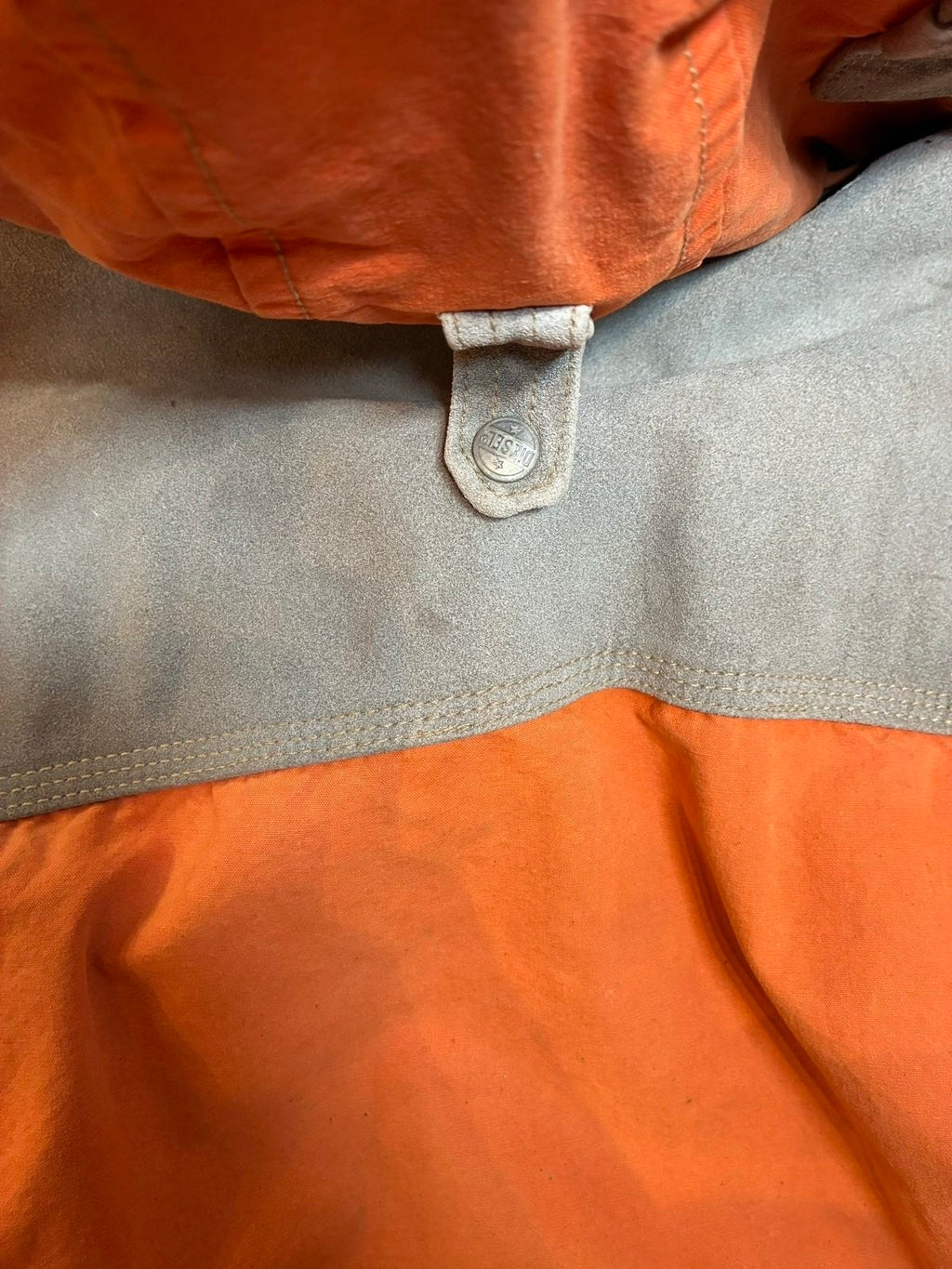 Diesel orange and grey hooded jacket with insulated design and vintage 90s style.