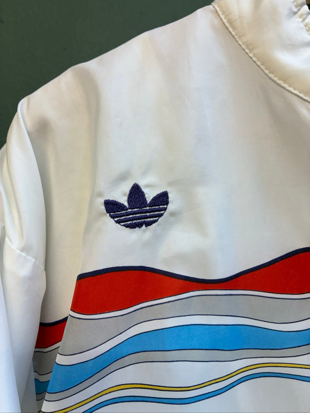 Adidas vintage blue, red, and white track jacket with logo and 80s design.