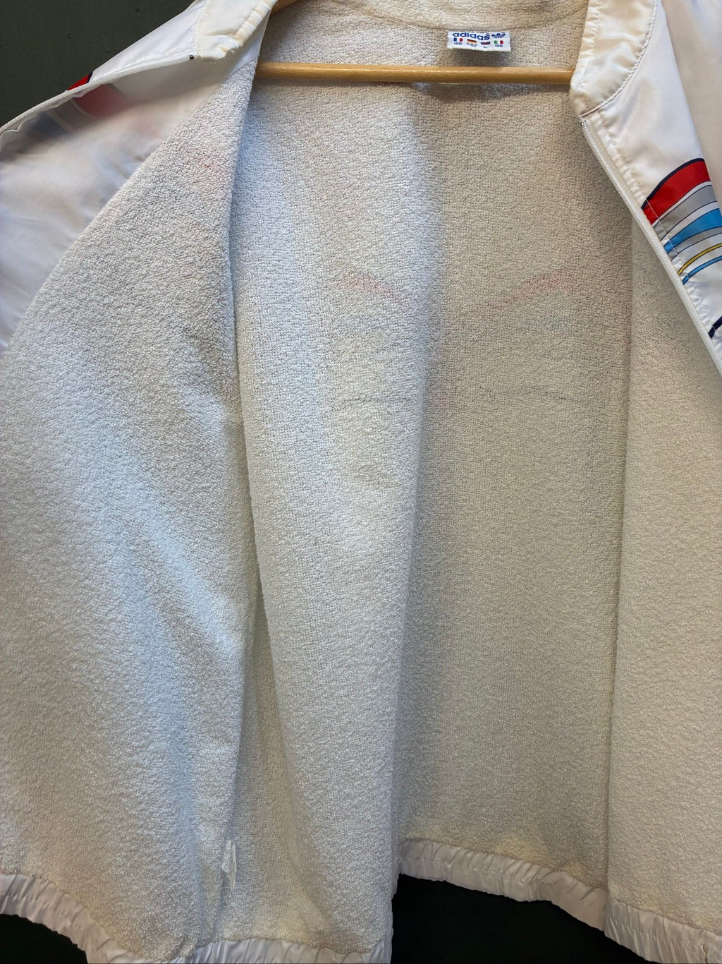 Adidas vintage blue, red, and white track jacket with logo and 80s design.