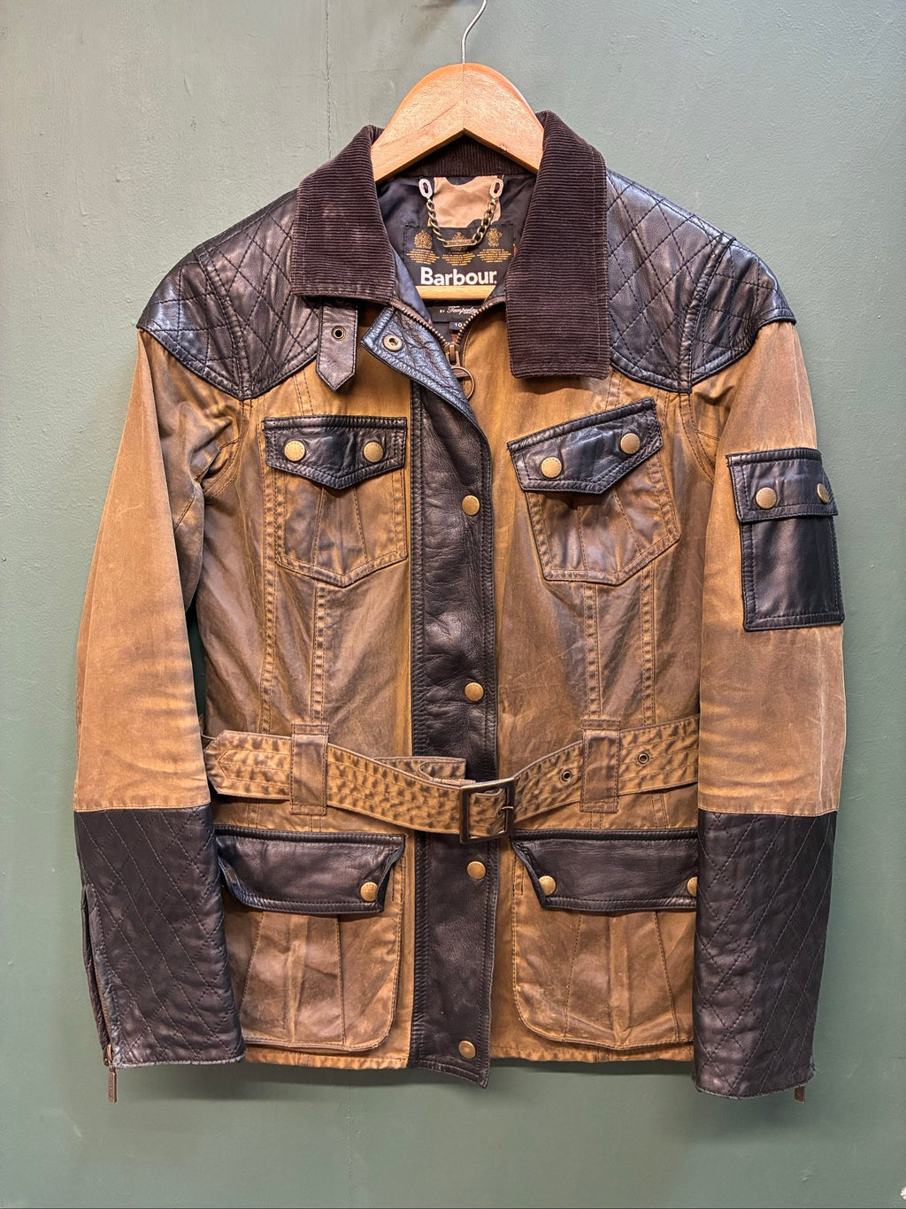 Barbour brown and black waxed cotton jacket with leather trims and gold label.