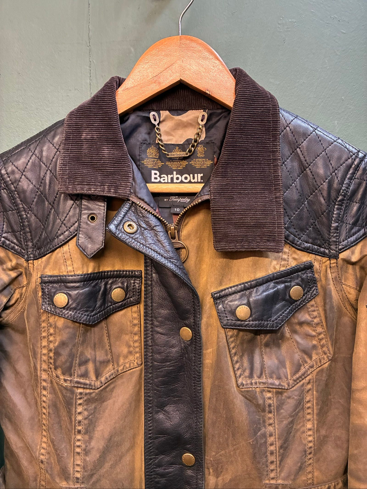 Barbour brown and black waxed cotton jacket with leather trims and gold label.