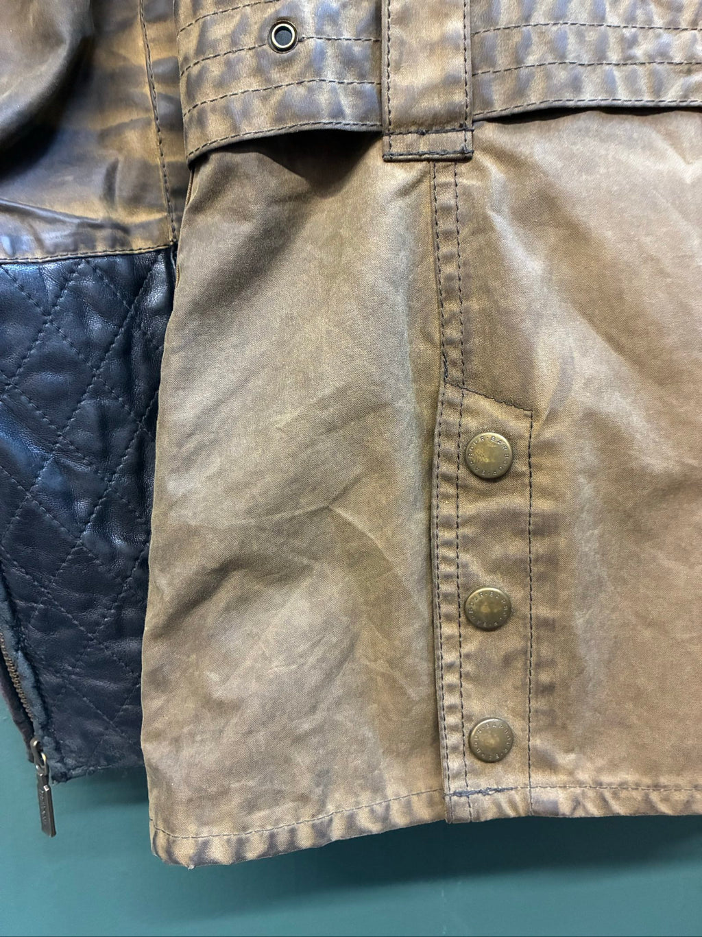 Barbour brown and black waxed cotton jacket with leather trims and gold label.