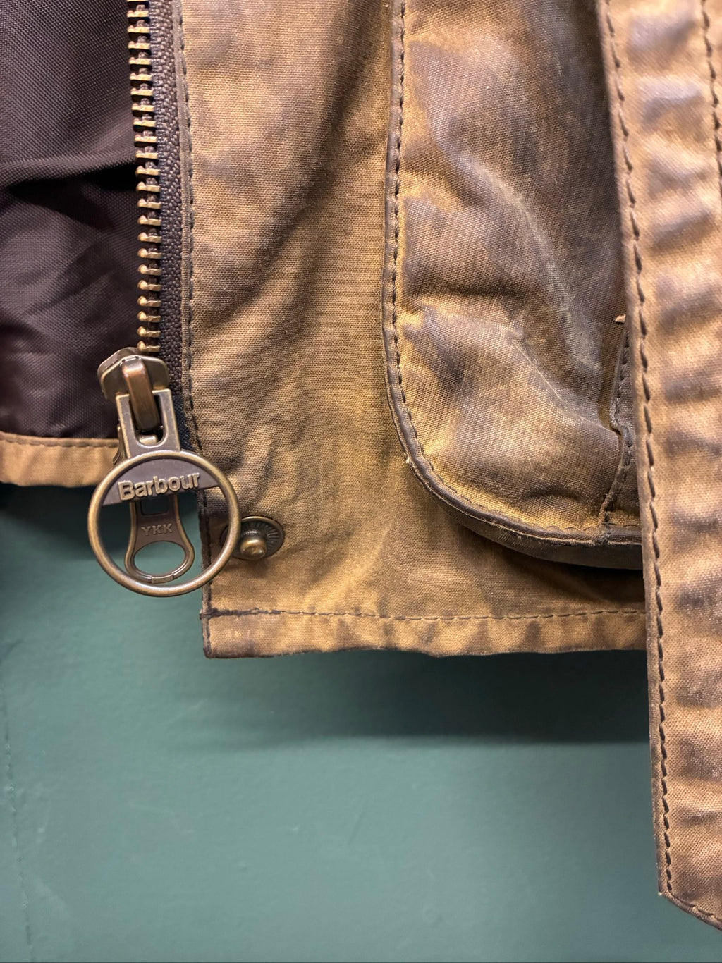 Barbour brown and black waxed cotton jacket with leather trims and gold label.