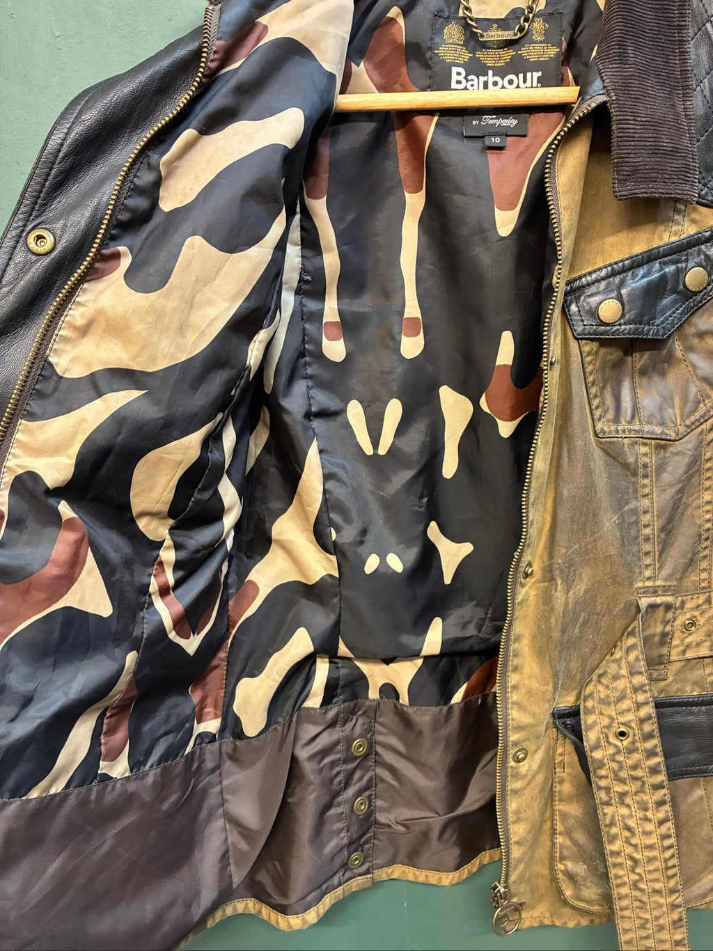 Barbour brown and black waxed cotton jacket with leather trims and gold label.