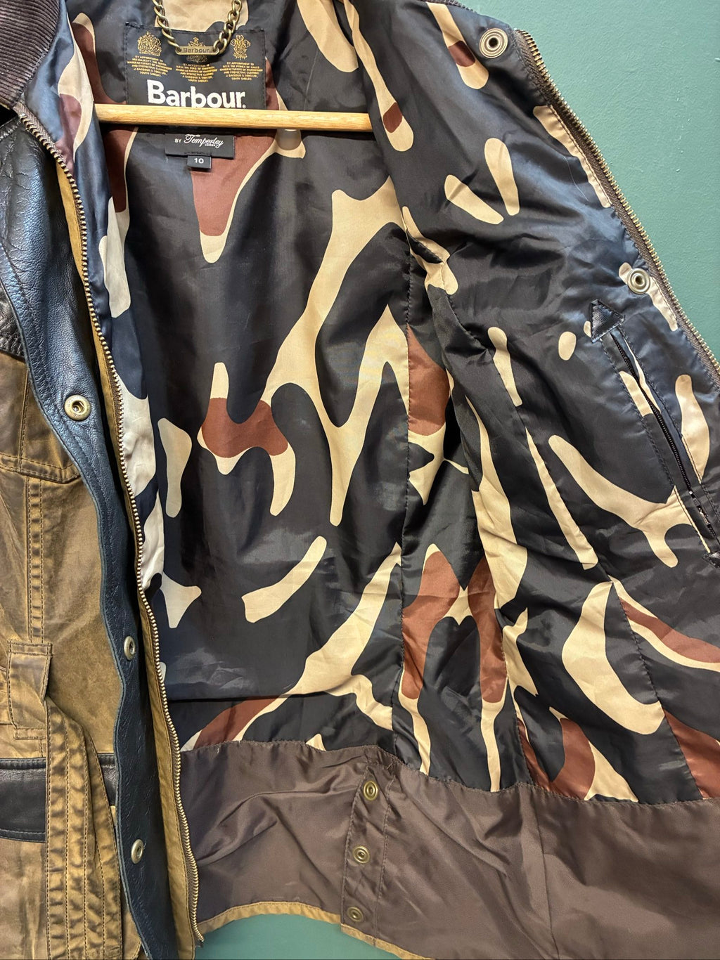 Barbour brown and black waxed cotton jacket with leather trims and gold label.