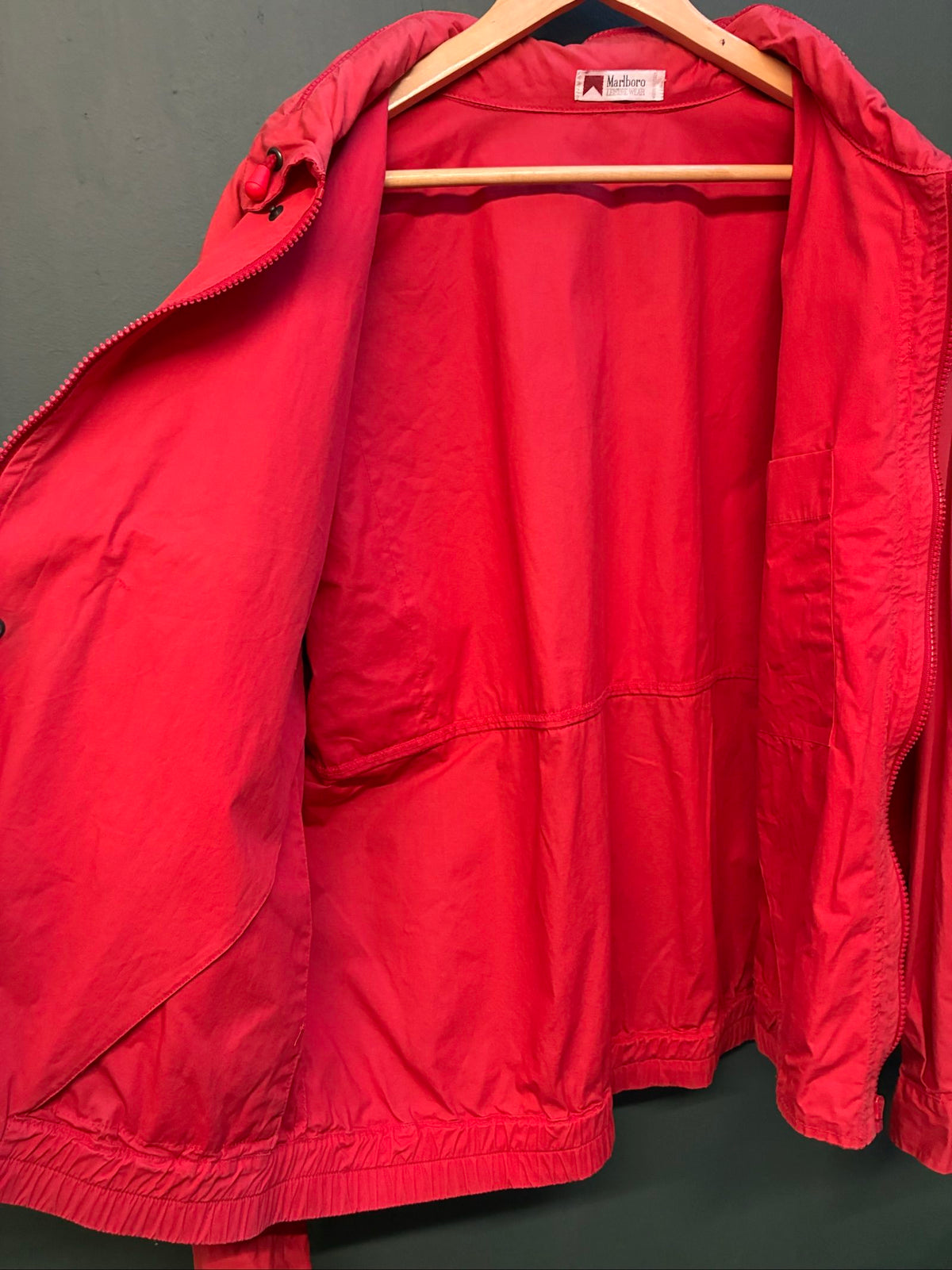 Marlboro vintage red cotton jacket with hood, snap pockets, subtle branding, 80s style.