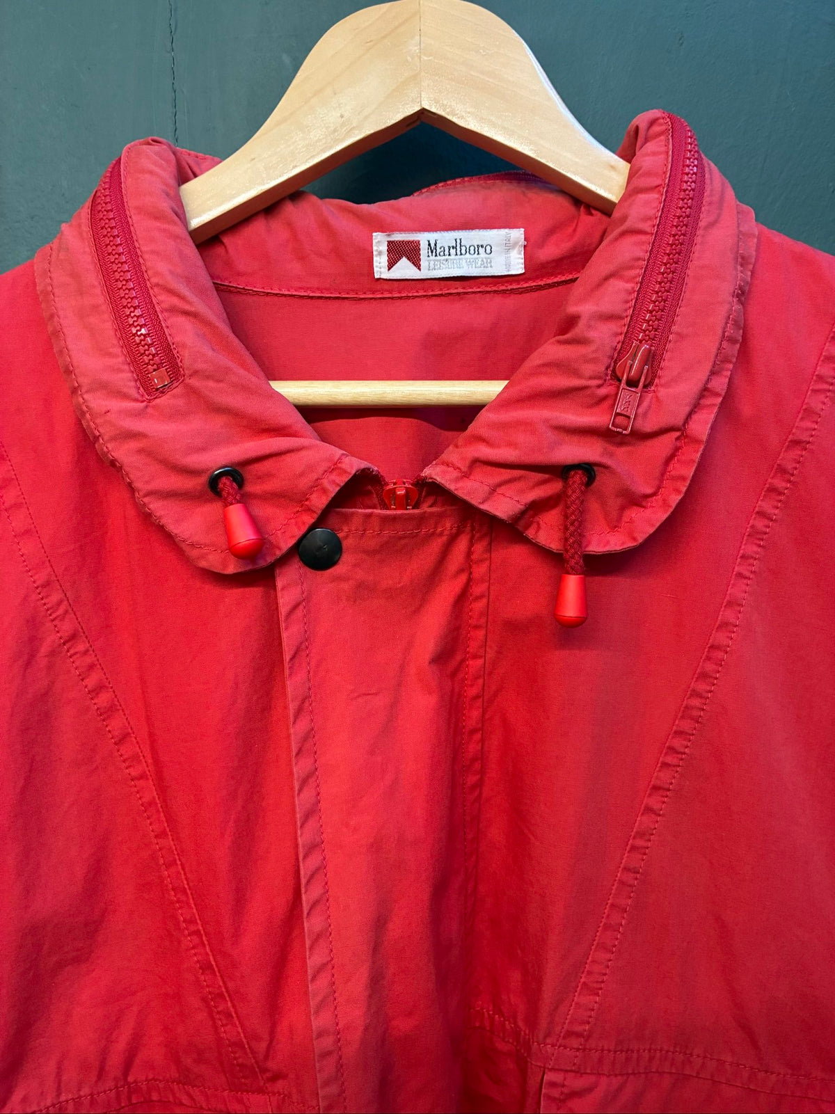 Marlboro vintage red cotton jacket with hood, snap pockets, subtle branding, 80s style.