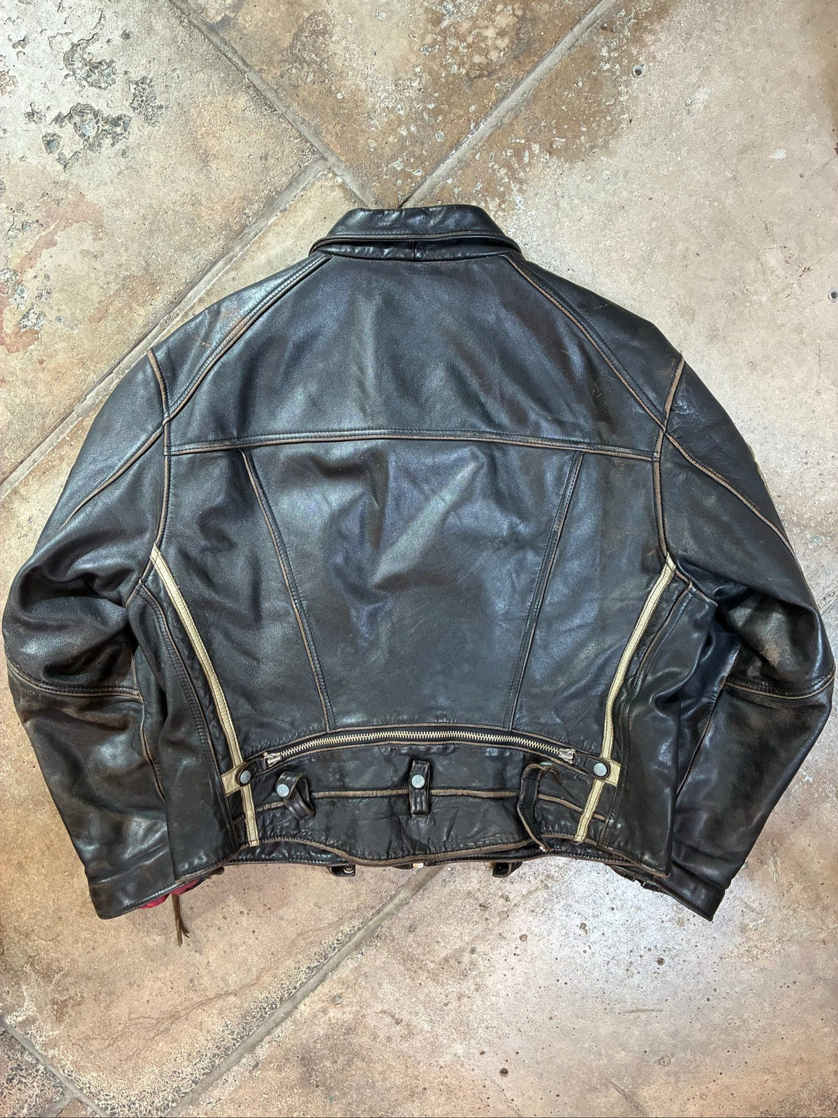 Diesel beige and black leather motorcycle jacket with quilted insulation and zipper pockets.