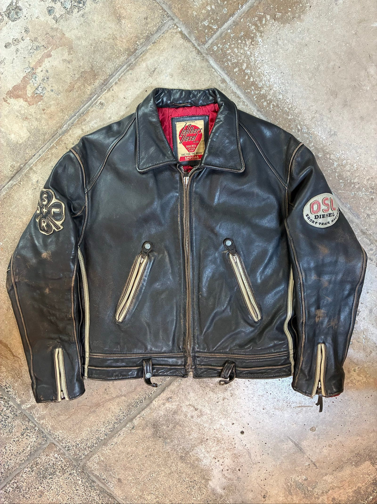 Diesel beige and black leather motorcycle jacket with quilted insulation and zipper pockets.