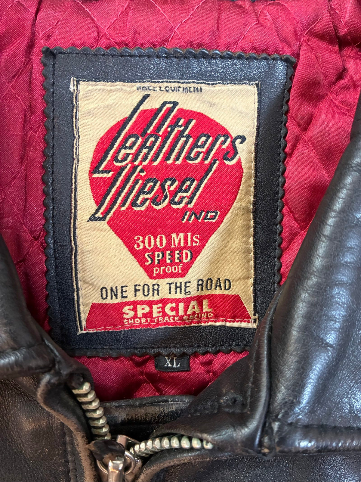 Diesel beige and black leather motorcycle jacket with quilted insulation and zipper pockets.