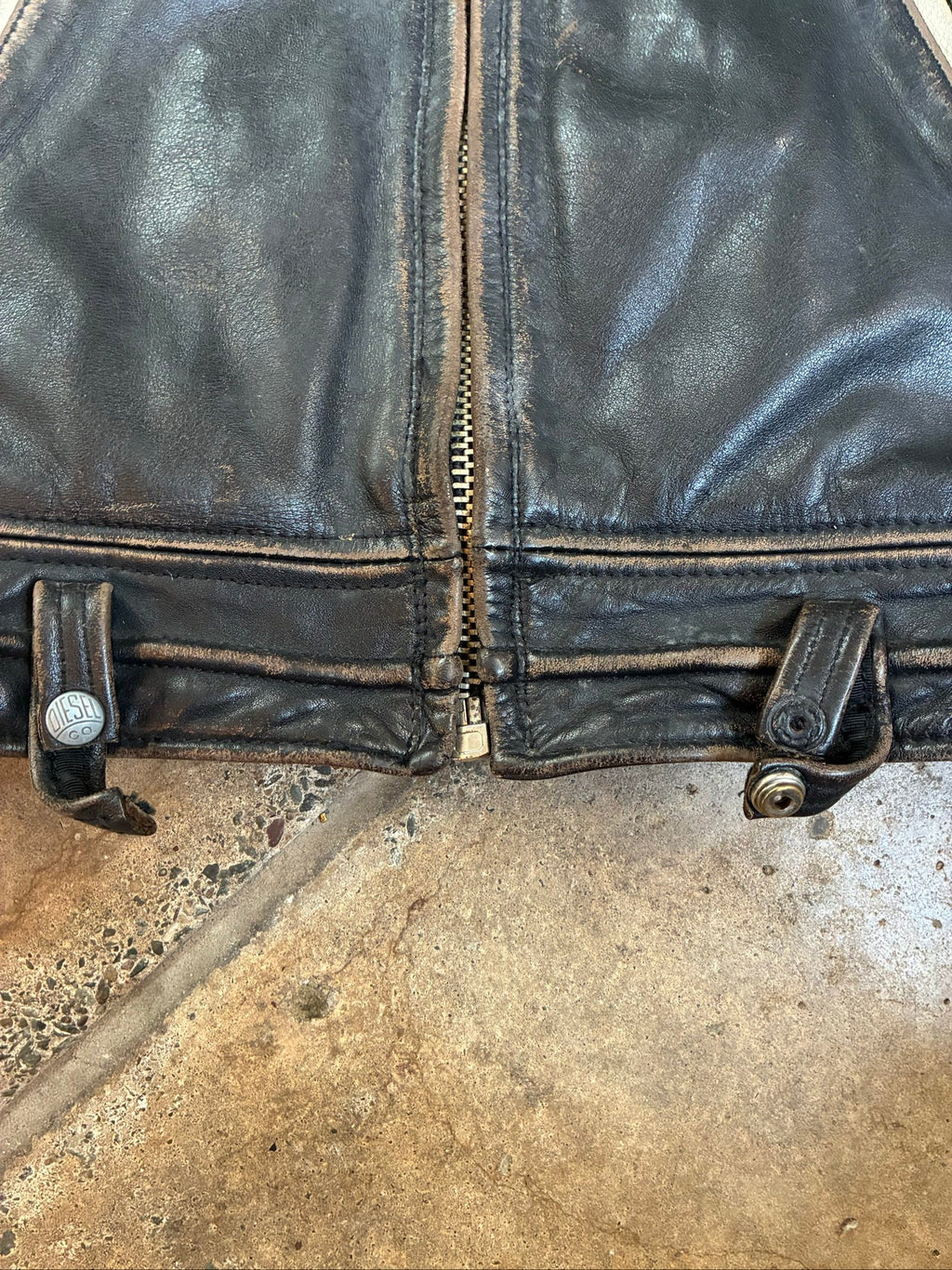 Diesel beige and black leather motorcycle jacket with quilted insulation and zipper pockets.