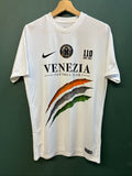 Nike football shirt white with raised Venezia logos, black and green accents.