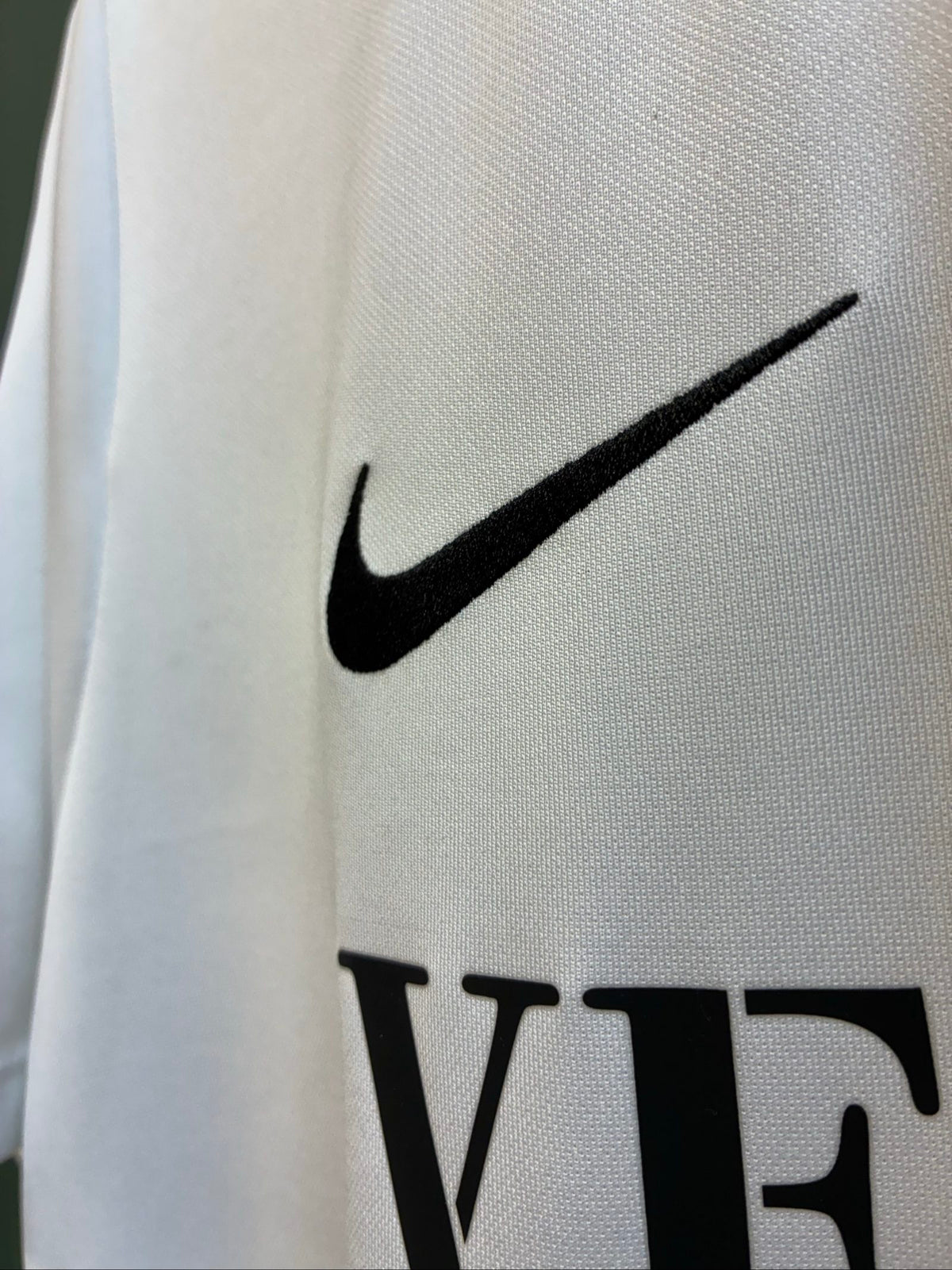 Nike football shirt white with raised Venezia logos, black and green accents.