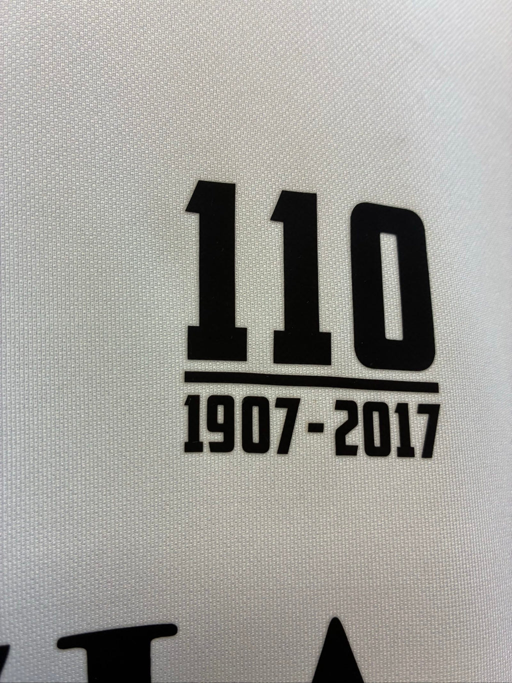 Nike football shirt white with raised Venezia logos, black and green accents.
