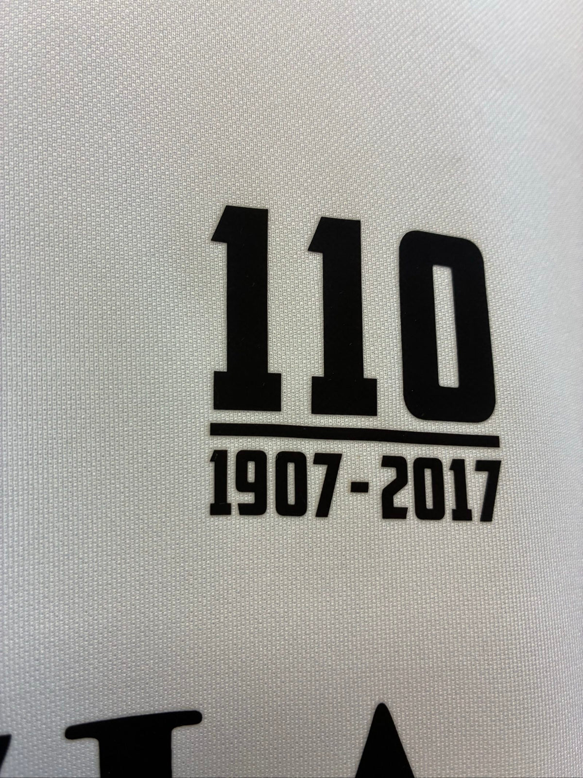 Nike football shirt white with raised Venezia logos, black and green accents.