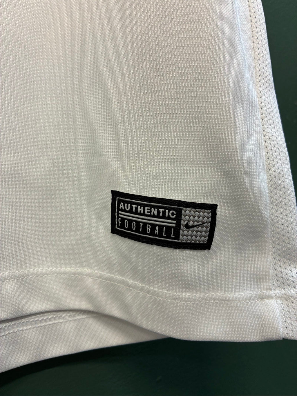 Nike football shirt white with raised Venezia logos, black and green accents.