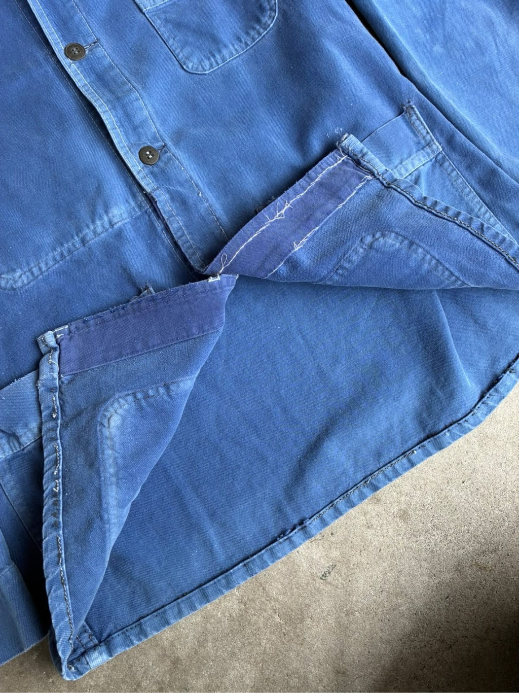 Vintage blue moleskin workwear jacket with distressed texture and no labels.