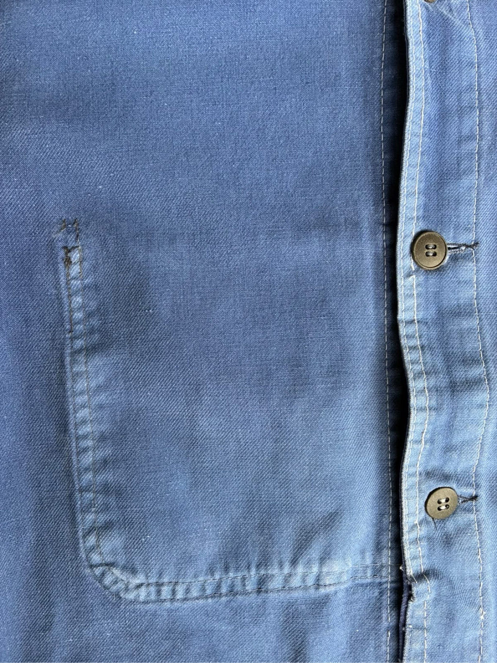 Vintage blue moleskin workwear jacket with distressed texture and no labels.