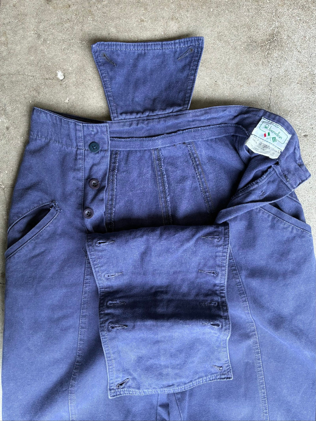 Benetton navy cotton workwear trousers with multiple button fastening and faded fabric.