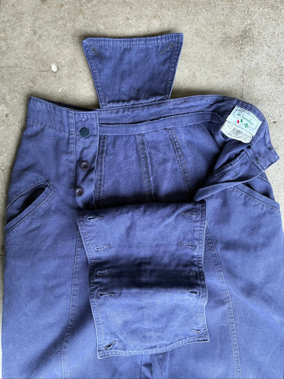 Benetton navy cotton workwear trousers with multiple button fastening and faded fabric.